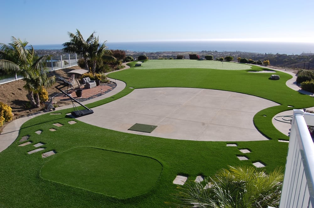 Backyard putting green with chipping areas and basketball court.