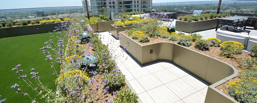 Artificial grass with planters on roof deck.